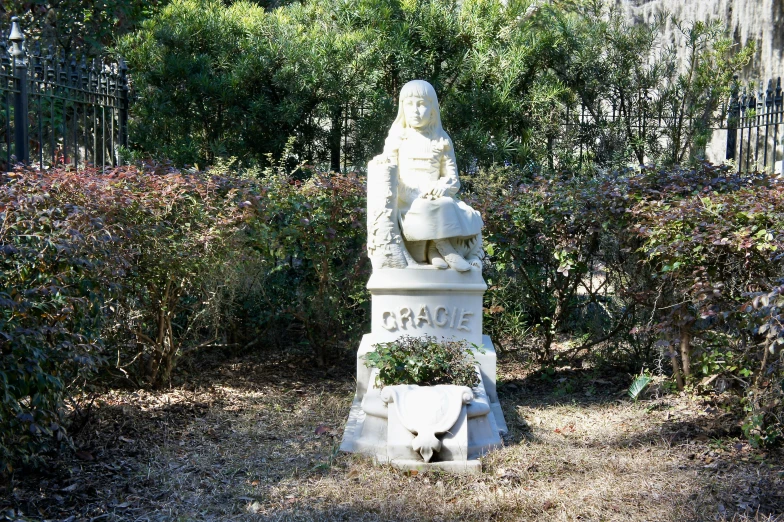 an older man monument sitting in front of a forest