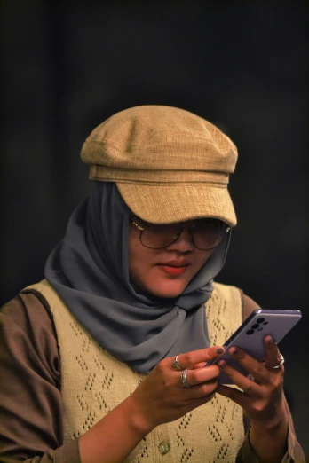 a woman wearing a burka using a cell phone