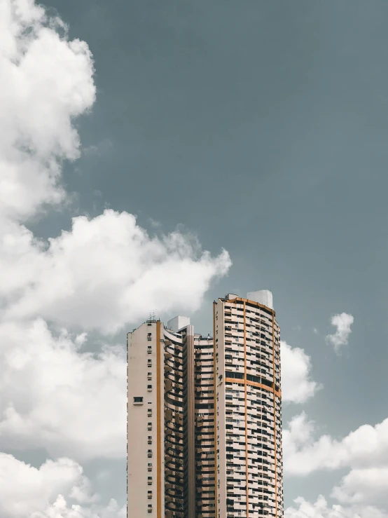 the building is near some trees and some clouds