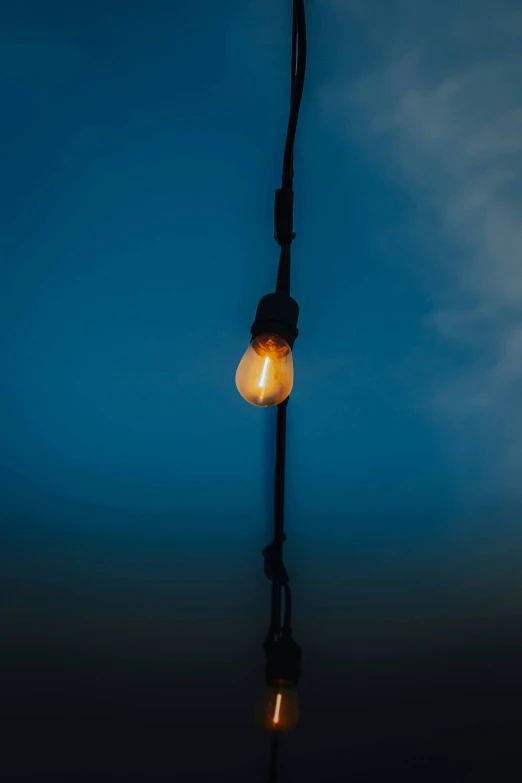 an odd looking street light in the middle of a dark sky