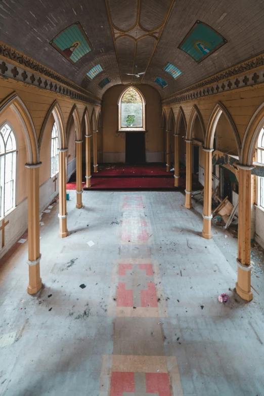 a large hall filled with arches and red carpeting