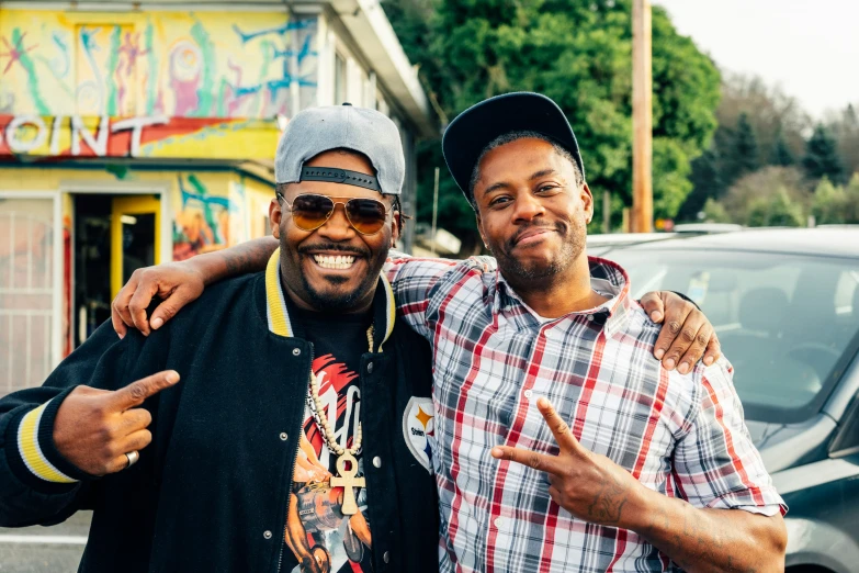 two men standing side by side posing for the camera