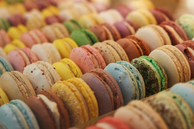 various colored macarons and pastries in a tray