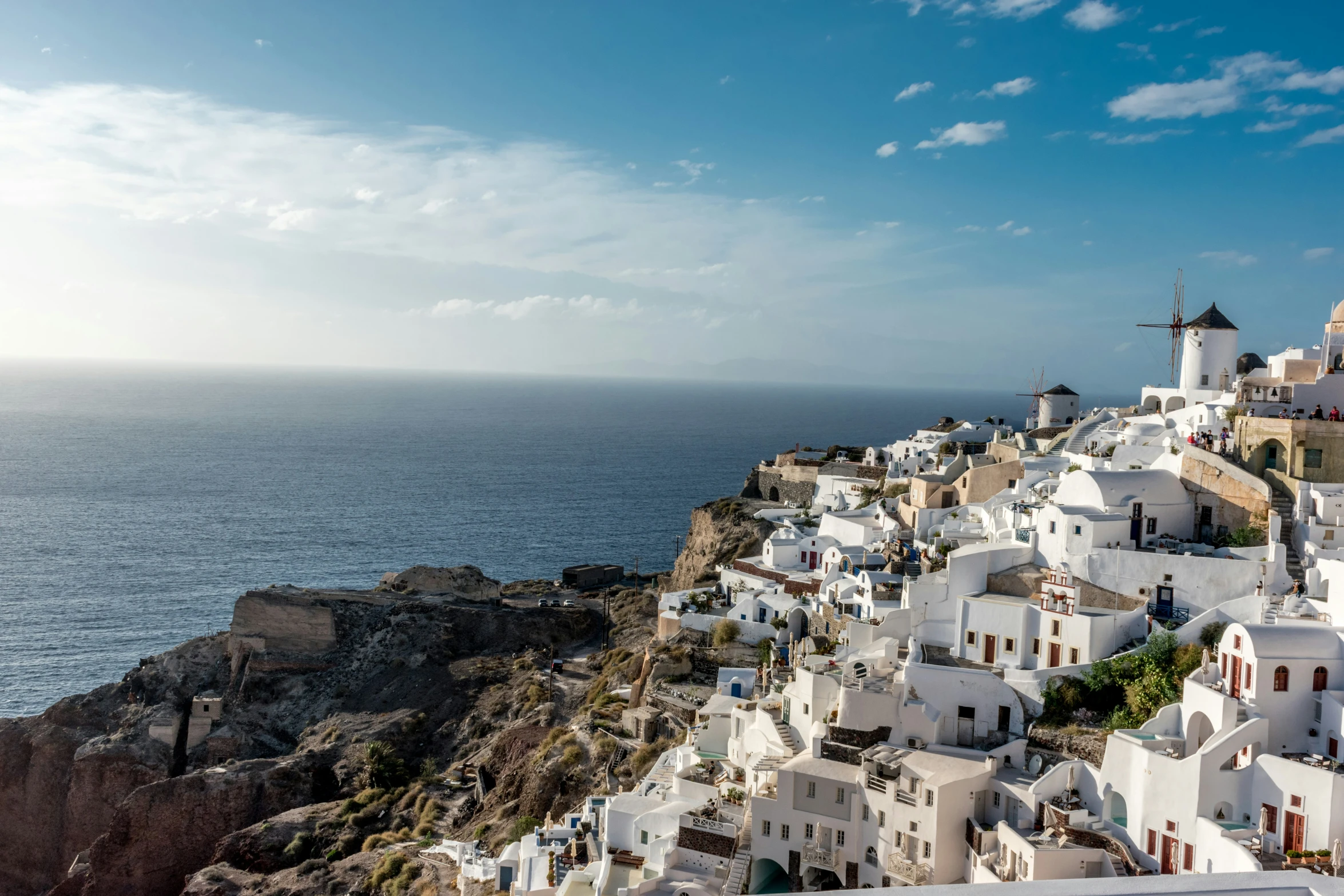 a white house on the cliff near the ocean