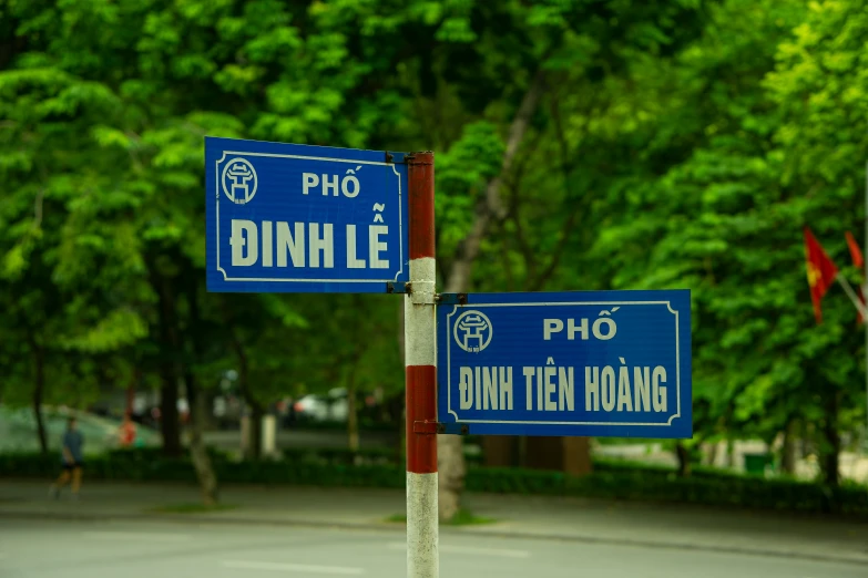 two signs on a pole that say binht lie and pinh tem hoang