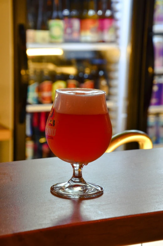 a large glass with some liquid in it sitting on a table