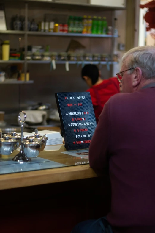 man waiting at counter waiting for his order in a restaurant