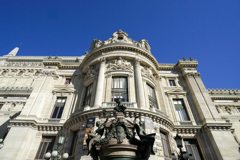 an ornamental statue sits in front of a fancy building