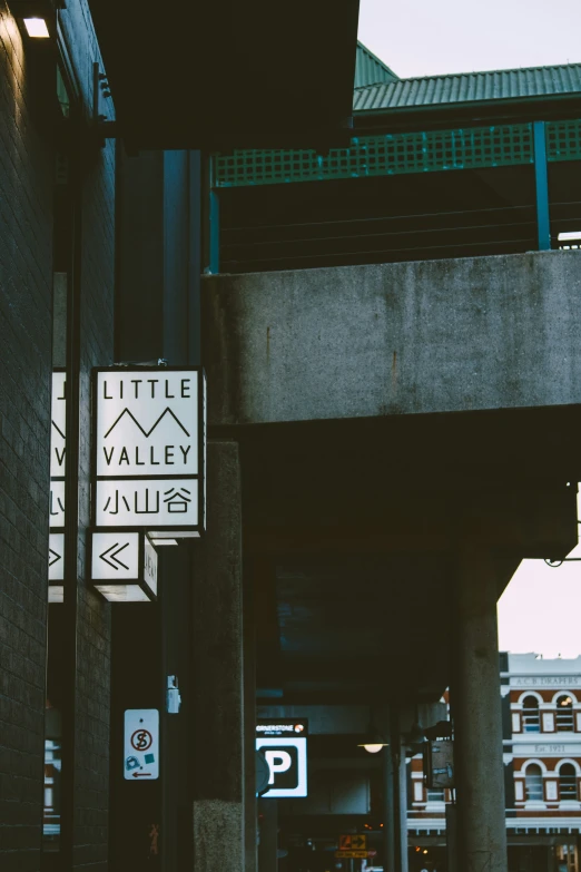 an empty street in front of a bridge