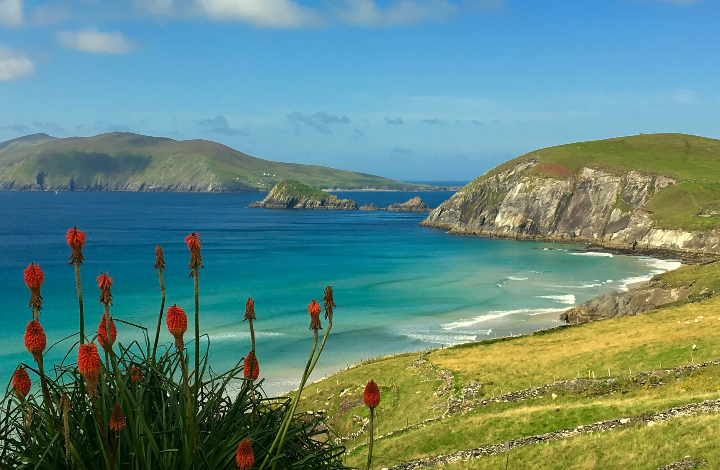 a small coastal beach and a group of mountains