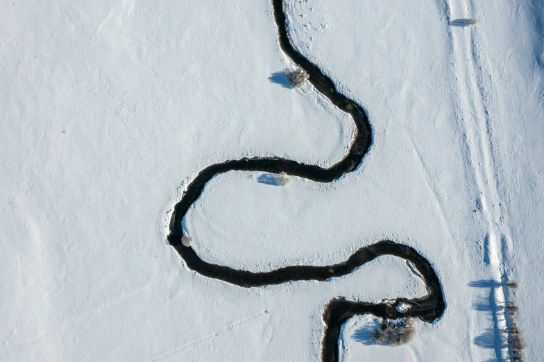 long black rope sitting on top of an icy ground