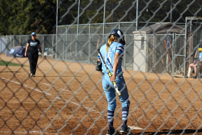 a girl with a baseball bat in a catchers mitt