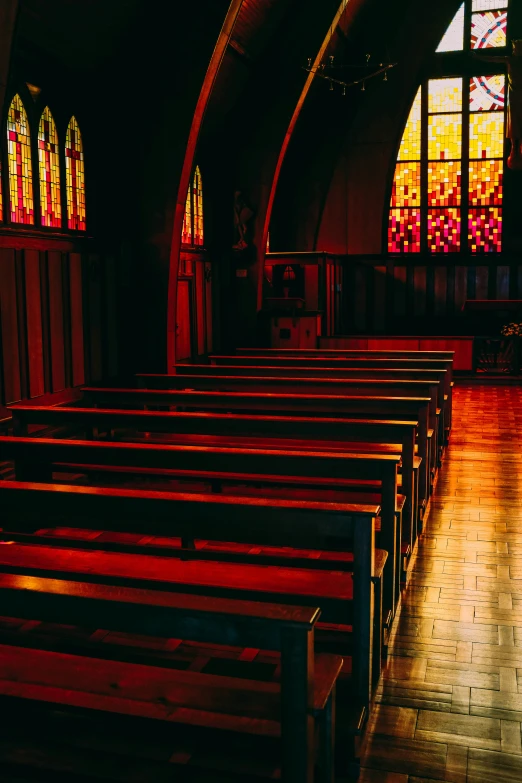 a church with stained glass windows and a long table