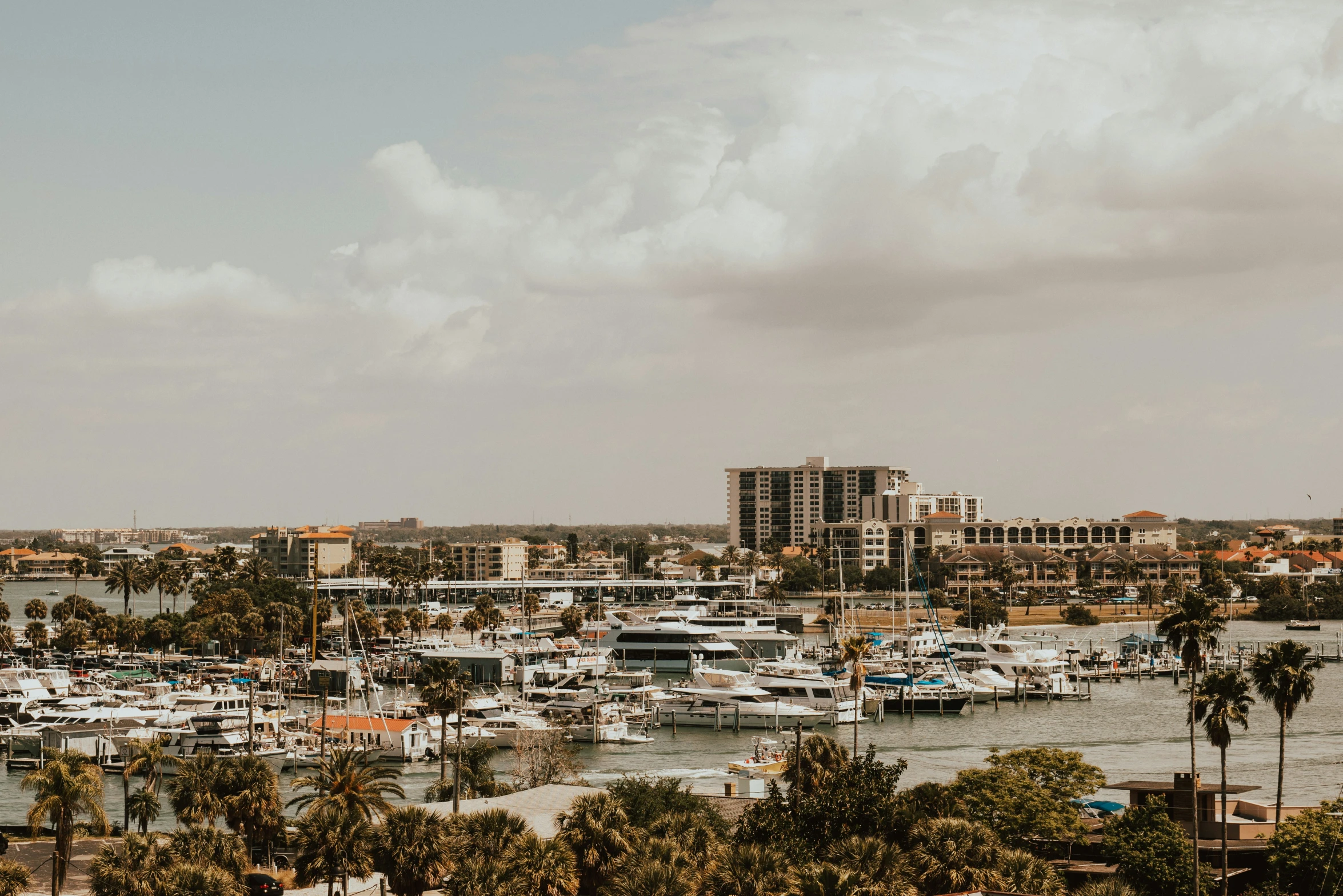 a harbor filled with lots of boats next to tall buildings