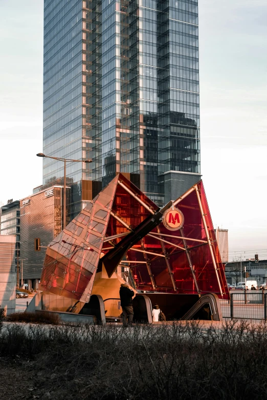 a building with its top in the shape of a red triangle