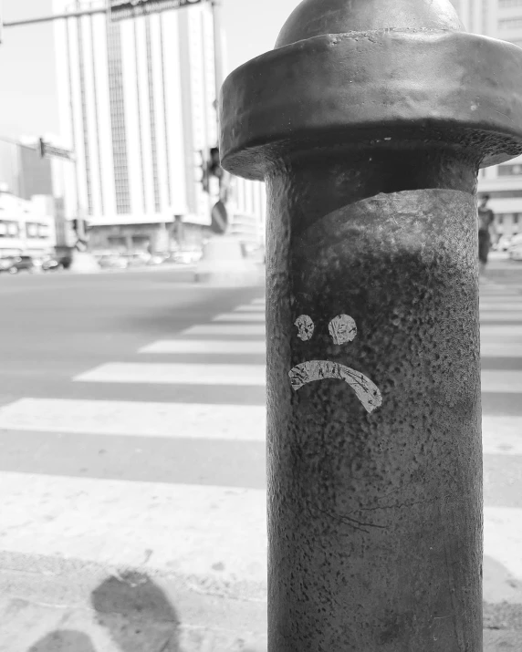 a fire hydrant painted with stickers is on the sidewalk