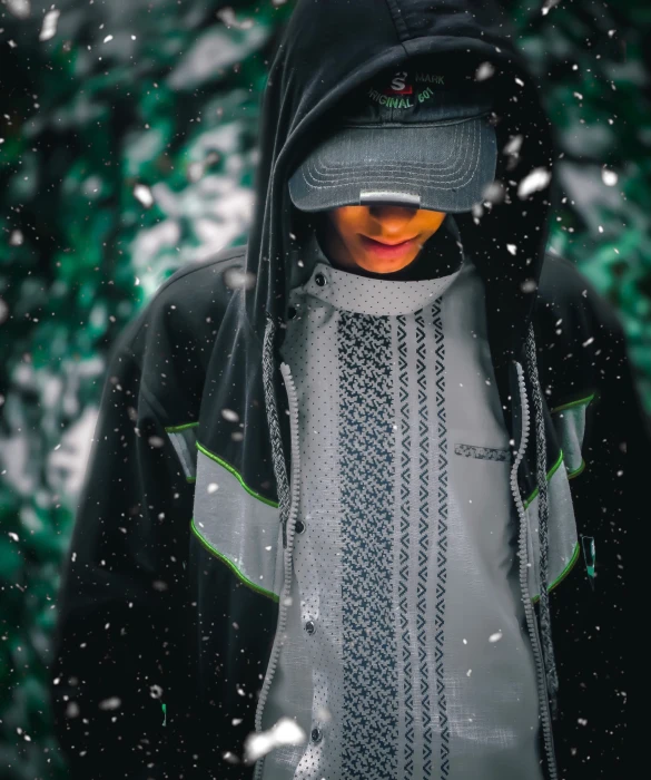 a  in the snow wearing a hat and jacket