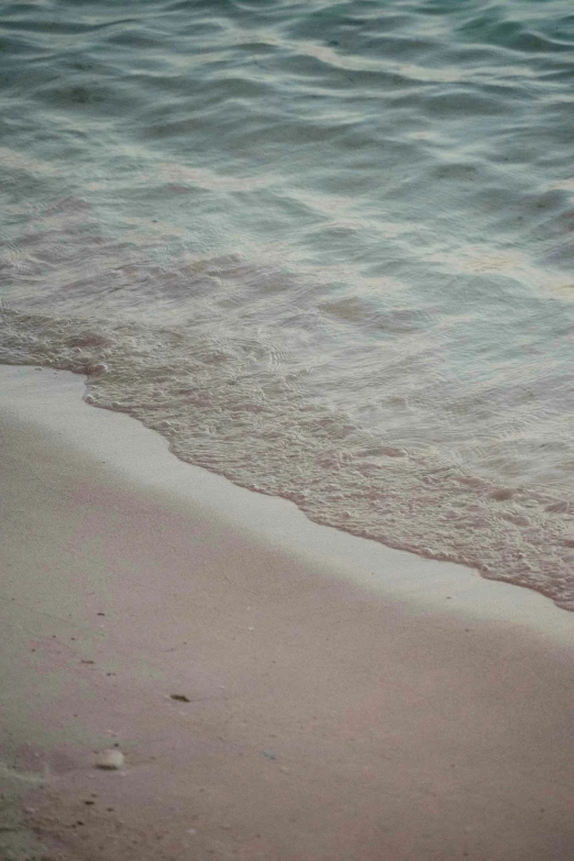 an ocean is shown with small waves coming in