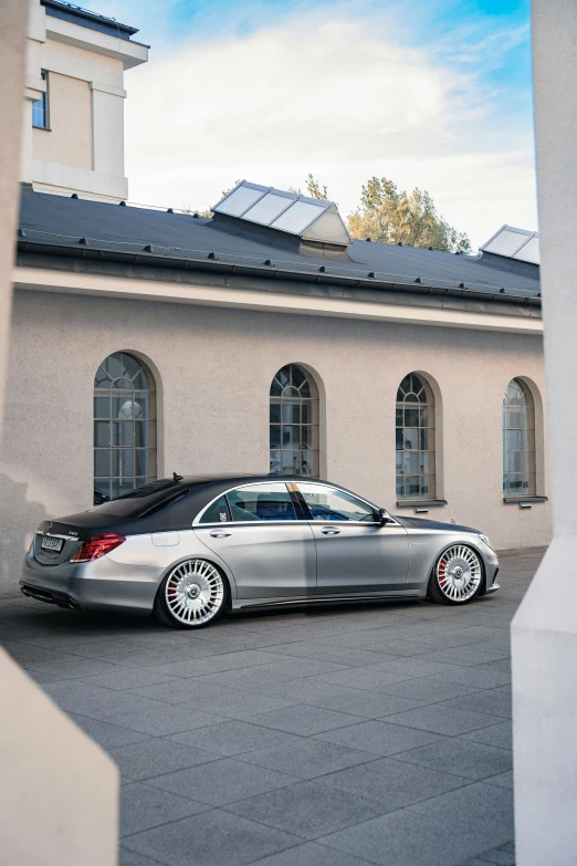 a very nice car in front of a big building