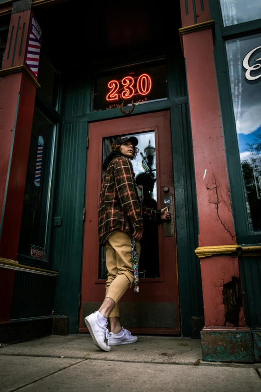 a woman standing in front of a red building