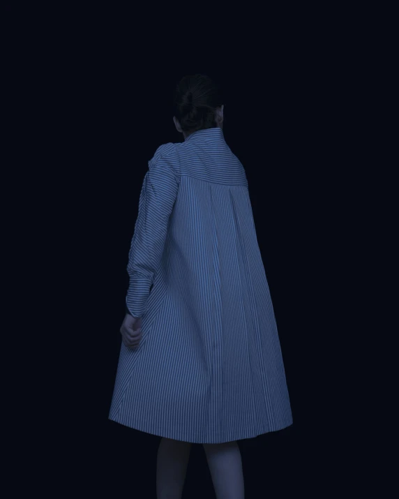 a woman standing in a dark room