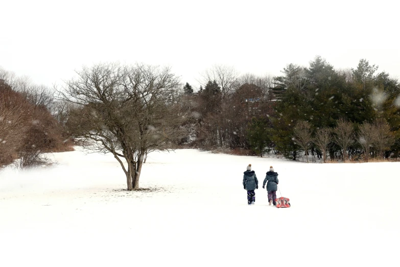 two people in the snow and one holding an umbrella