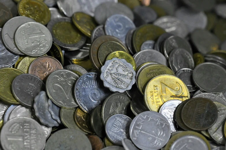 many different foreign coins are scattered throughout the image
