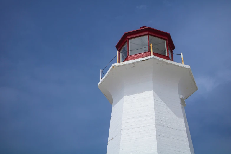 a lighthouse is sitting on top of a mountain