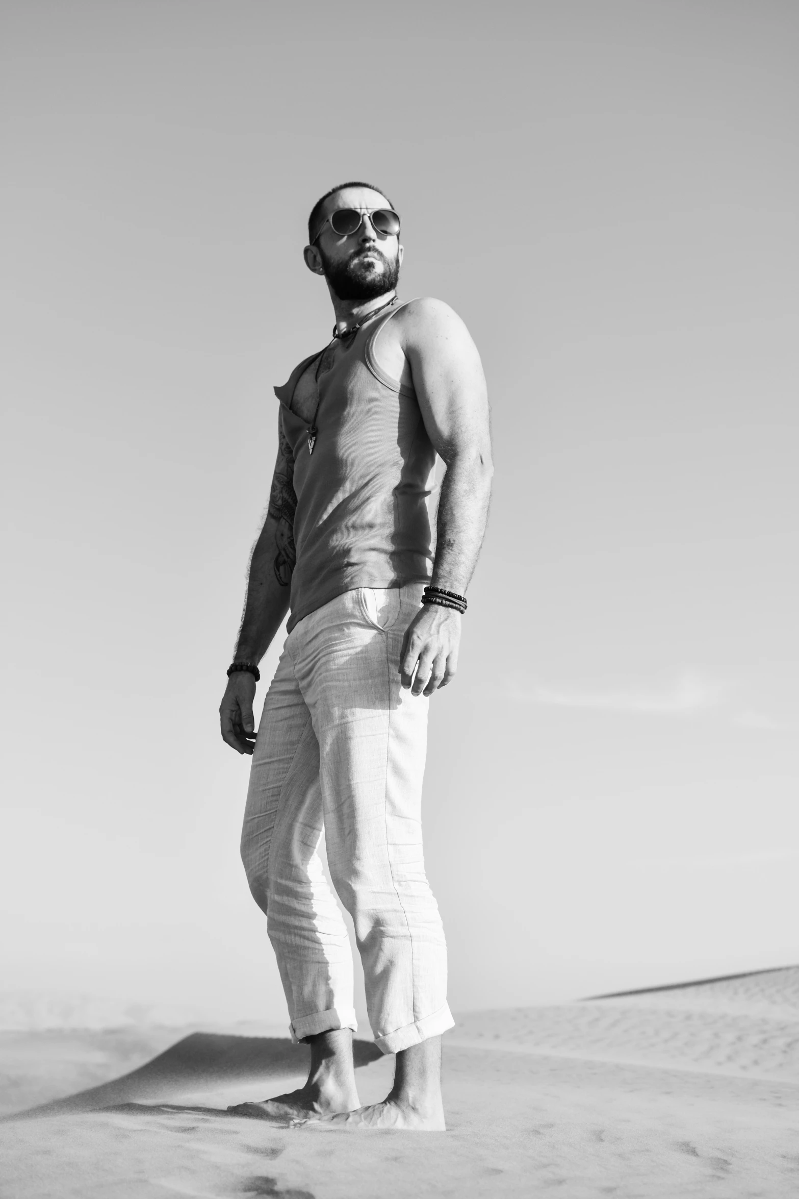 a man with beard in the desert under a clear sky