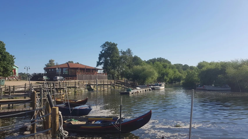 several boats on the water near wooden bridges