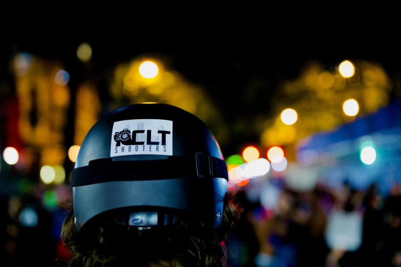 a person wearing a helmet with lights in the background