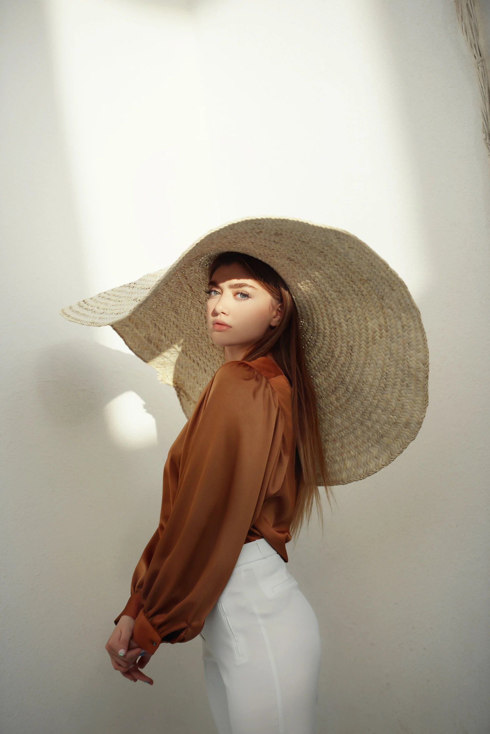 a woman wearing a large hat over her head