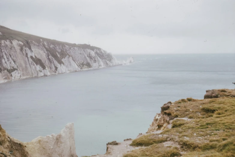 a body of water with white cliffs near it