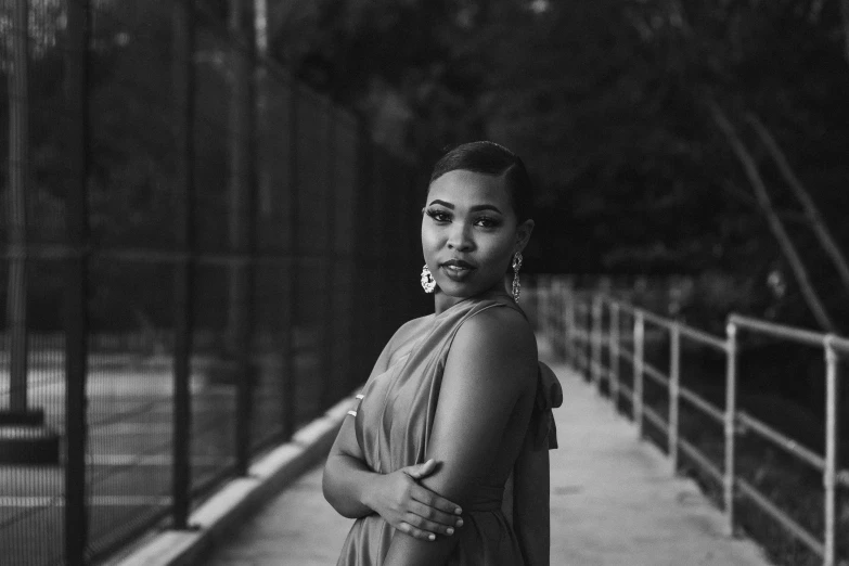 an african american woman standing on a walkway