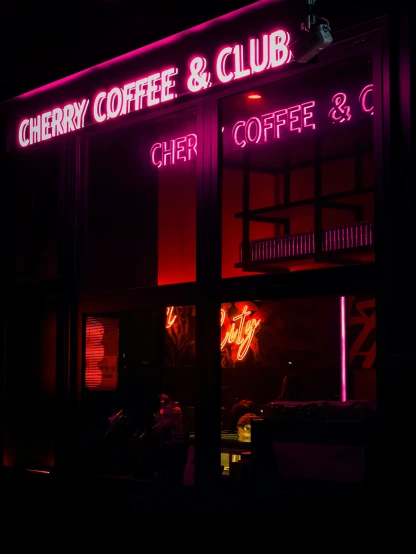 a store front with neon lights outside the door
