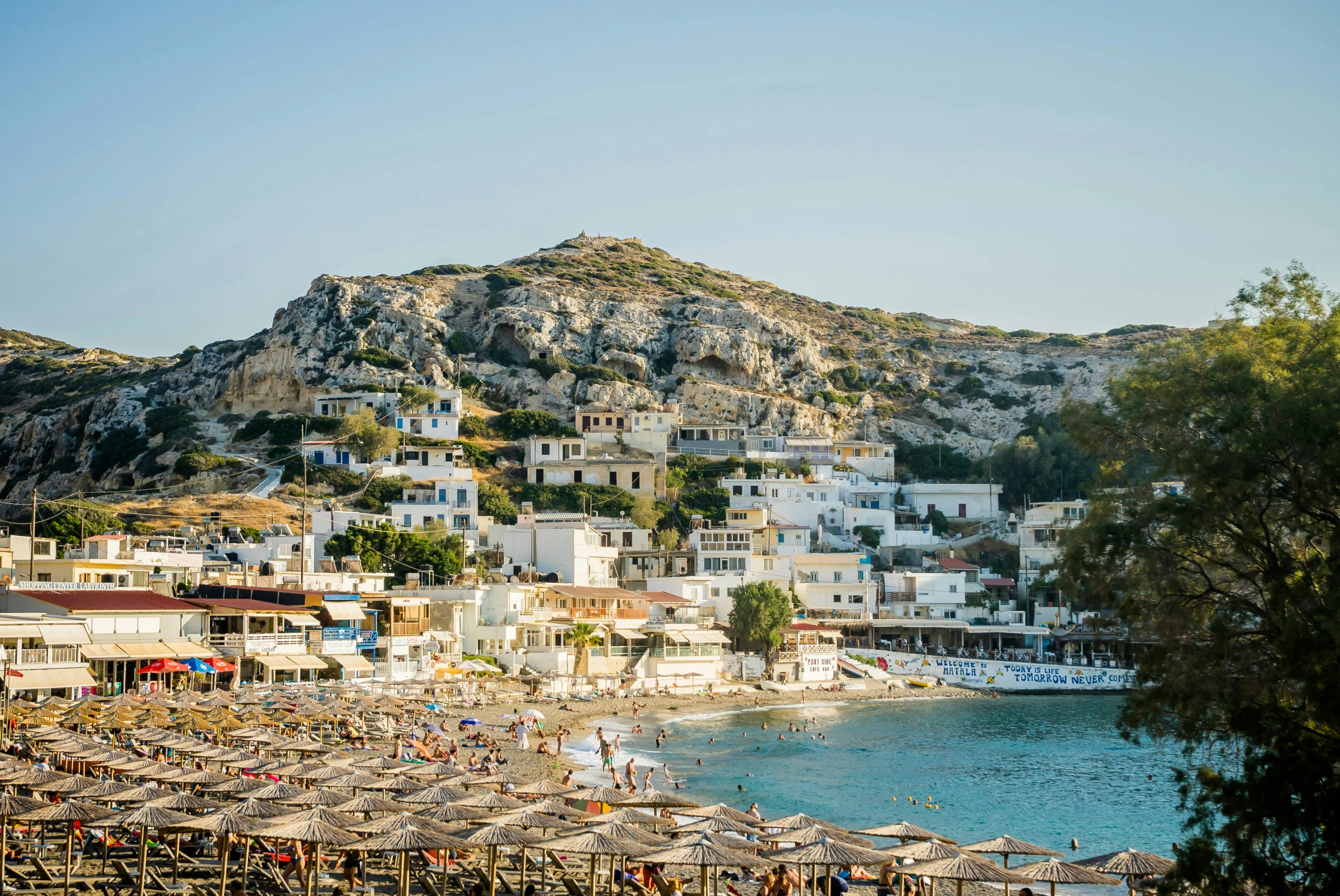 the small fishing village on a hillside overlooking a body of water