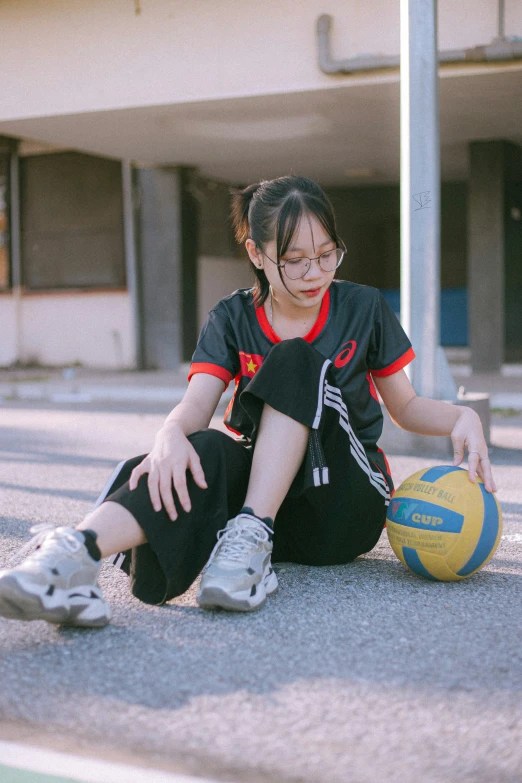  sitting with basketball ball on concrete surface