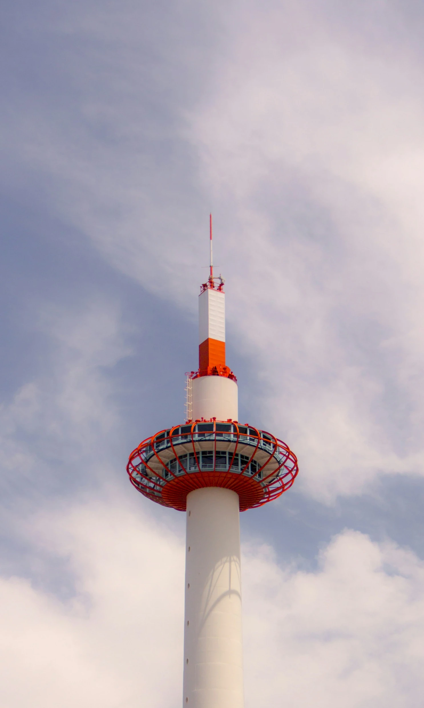 an airplane flies by a tower with some stairs