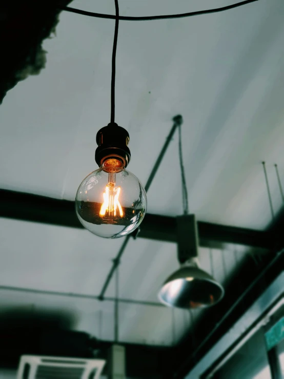 a vintage fashioned light bulb hanging from a ceiling