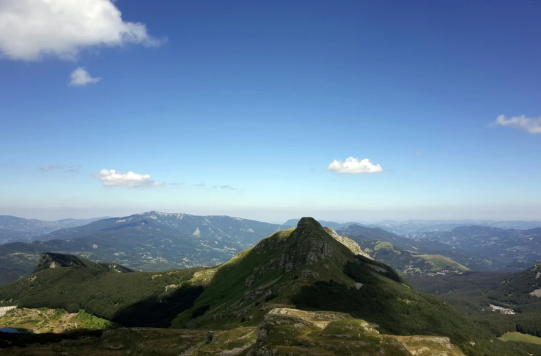 a mountain scene from a high point with a blue sky