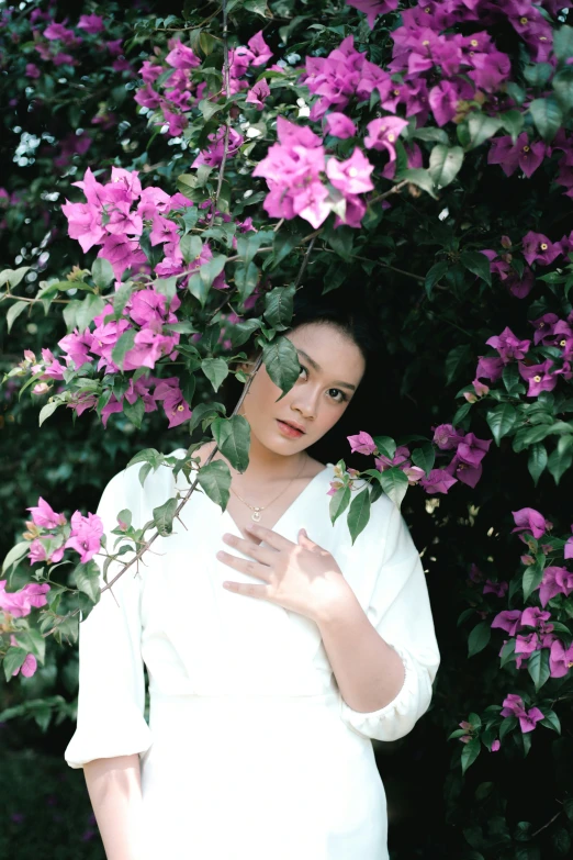 an image of a beautiful woman that is hiding in flowers