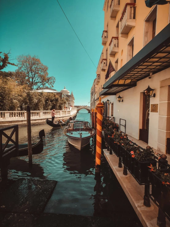 several boats are docked at the side of the waterway