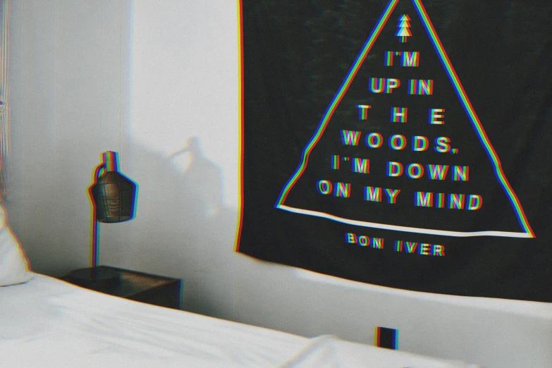a bed is in a bedroom with a poster