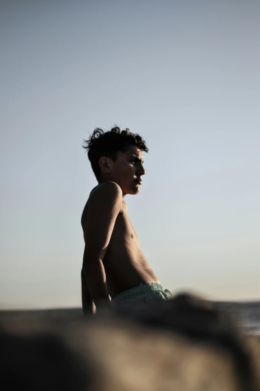 a man with a frisbee at the beach