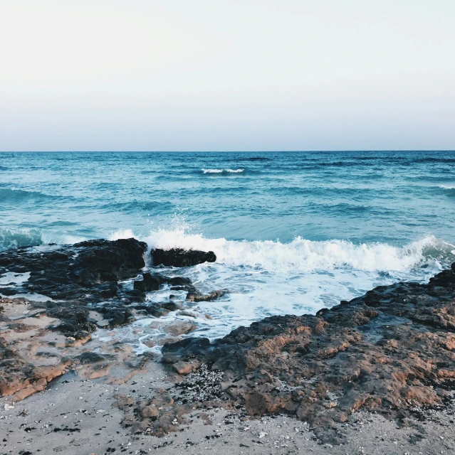 an ocean view with very strong waves crashing