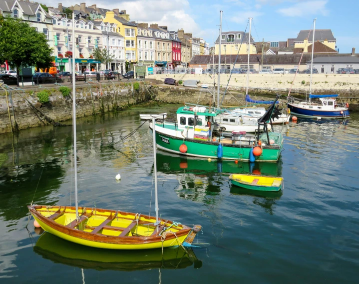 a few small yellow and green boats in the water