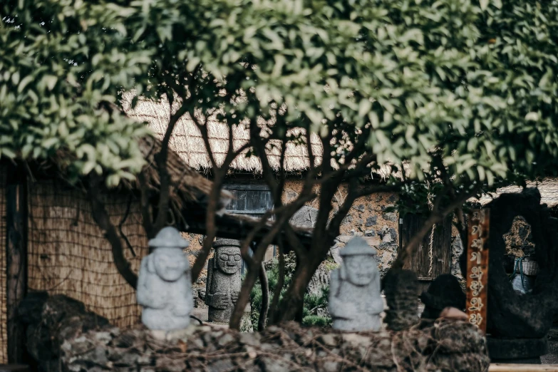 a group of statues and bushes surrounding some building