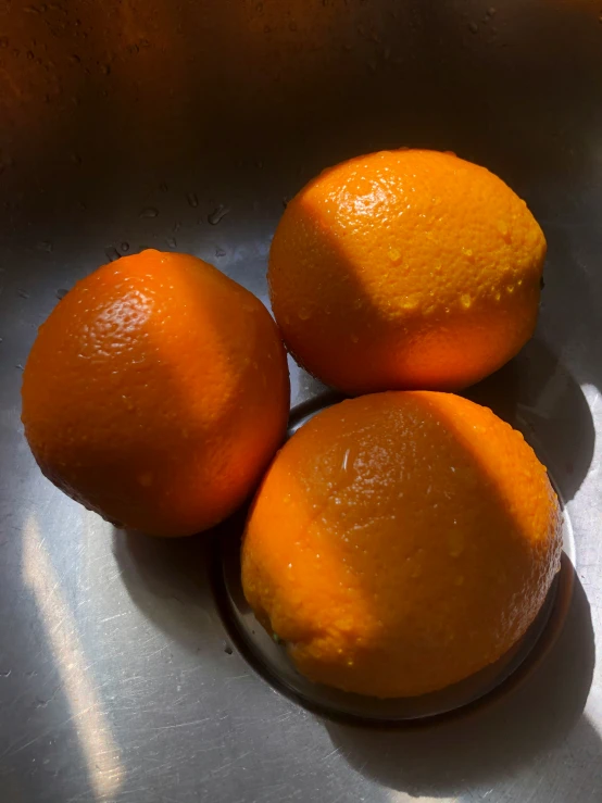 four oranges sitting on top of each other