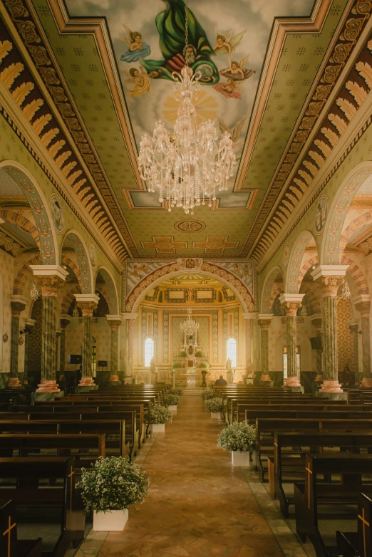 inside a church with chandeliers and a vaulted ceiling