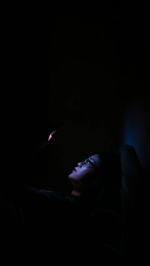 dark room with girl looking at wallpaper and lighting